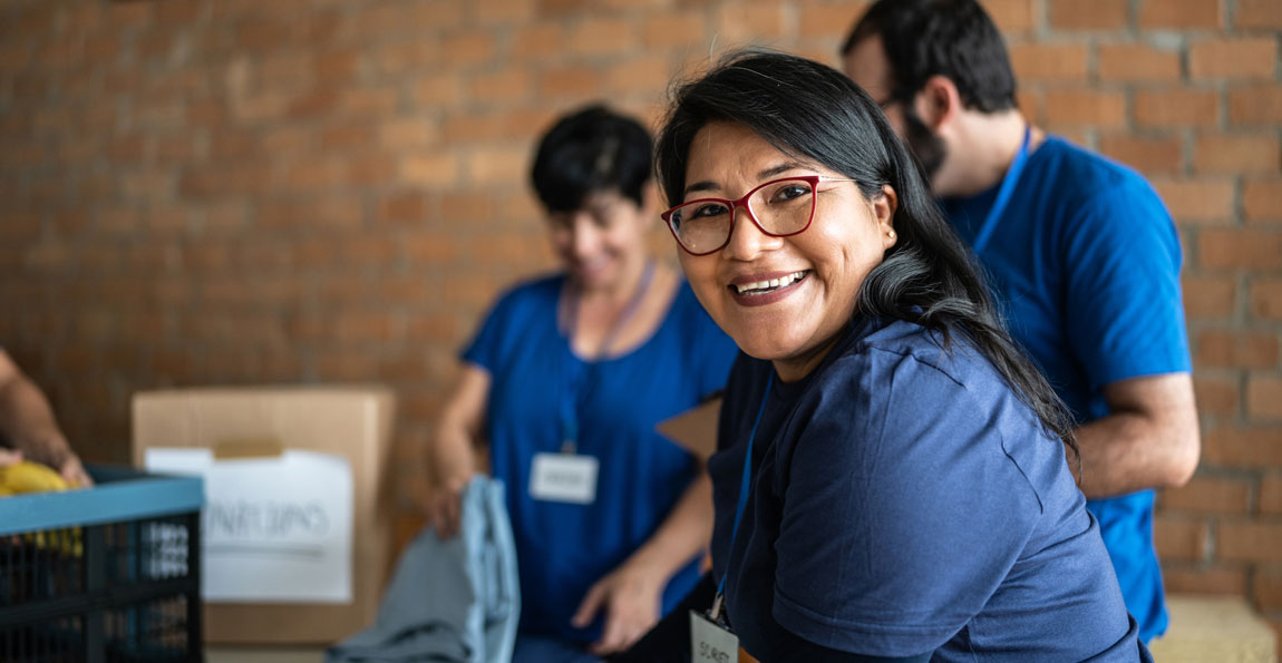 Smiling volunteers working at a nonprofit.