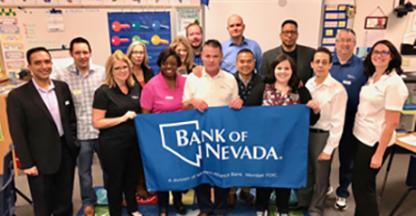 A group of people, including Bank of Nevada employees, posing in a classroom