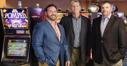 3 men standing in a casino