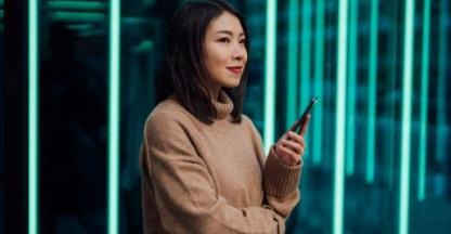 Asian woman holding a cell phone