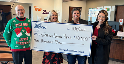 Northern Nevada HOPES members hold a donation check from First Independent Bank