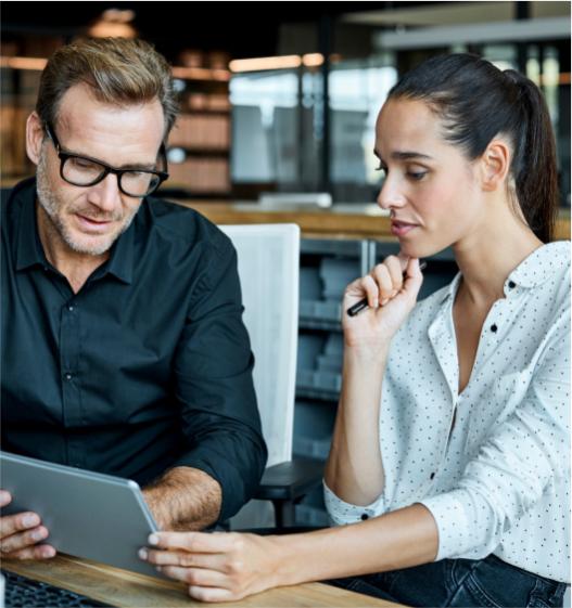 Two business people looking at a tablet together