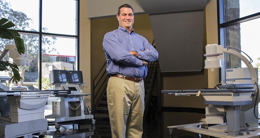 Chris Gleason, NextMed CEO, posing in a surgery suite