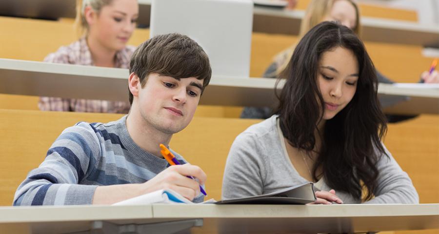Two students in a lecture hall