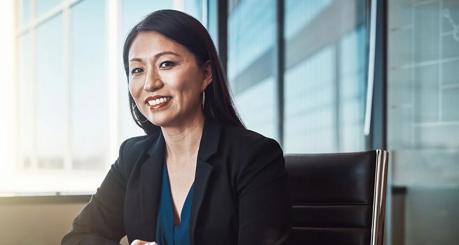 Businesswoman sitting in a chair smiling at the camera