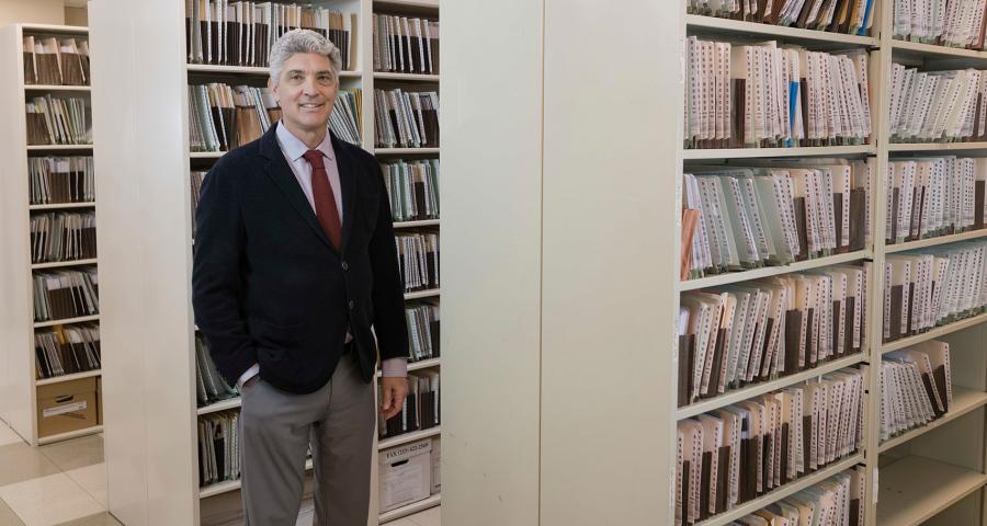 Man posing in a legal document file room