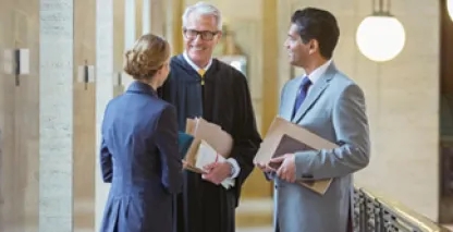 standing judge and two lawyers in a courthouse