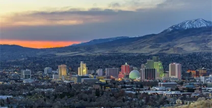 photo of a town surrounded by trees during sunset