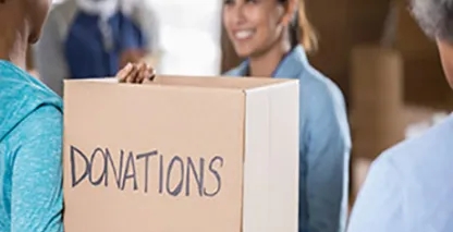 Woman holding a cardboard box for donations