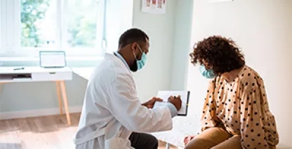 Woman at clinic getting checkup by doctor