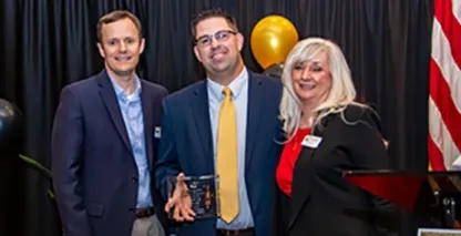 Three Bank of Nevada employees posing with an award