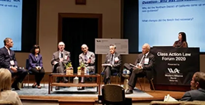people sitting in a panel on a stage