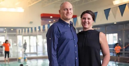 Aqua Tech owners posing for the camera by an indoor pool