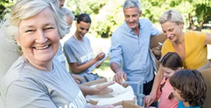 A group of people working together in a park setting