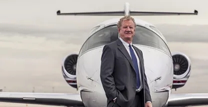 Will Cutter, Cutter Aviation CEO posing in front of a plane