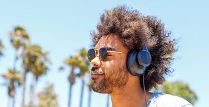 Man wearing sunglasses & headphones