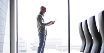 Man looking at tablet in conference room