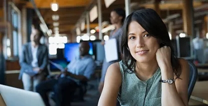 Businesswoman looking into the camera in an open office setting