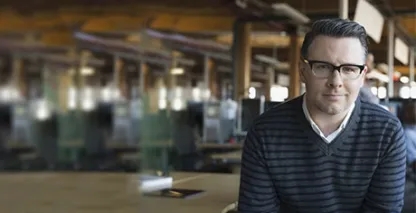 Businessman looking into the camera in an open office setting