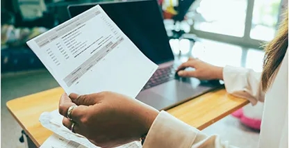 Woman holding a paper statement