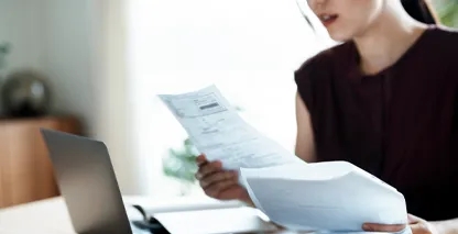 Woman looking at paper documents