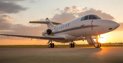 Private jet on the runway in front of the sunset