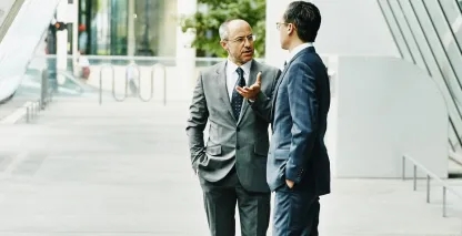 Two financiers having a conversation outside
