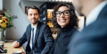 A businesswoman smiling during a meeting with her bankers