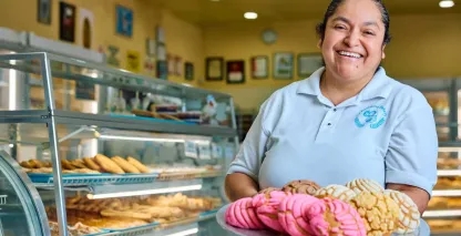 Woman holding a tray of pastries