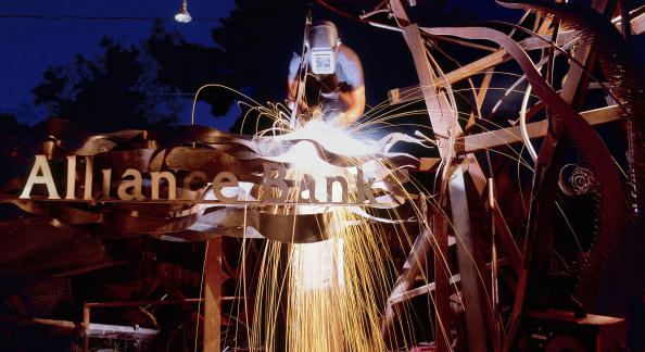 Welder working on metal Alliance Bank of Arizona sign