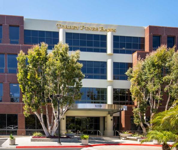 A large modern building with a Torrey Pines Bank sign